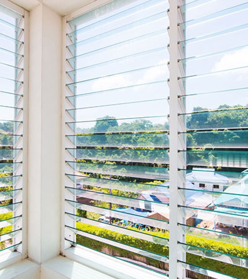 A window with its blinds open, inviting light inside, reflecting the professionalism of Jalousie Window Cleaning Service.